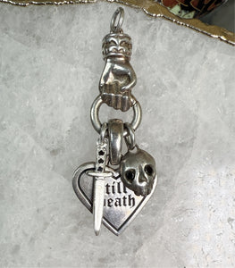 black diamond dagger charm on a charm holder with other charms