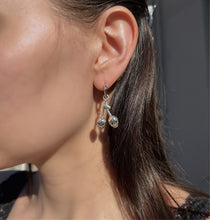 Load image into Gallery viewer, cherry skull earrings being worn by model